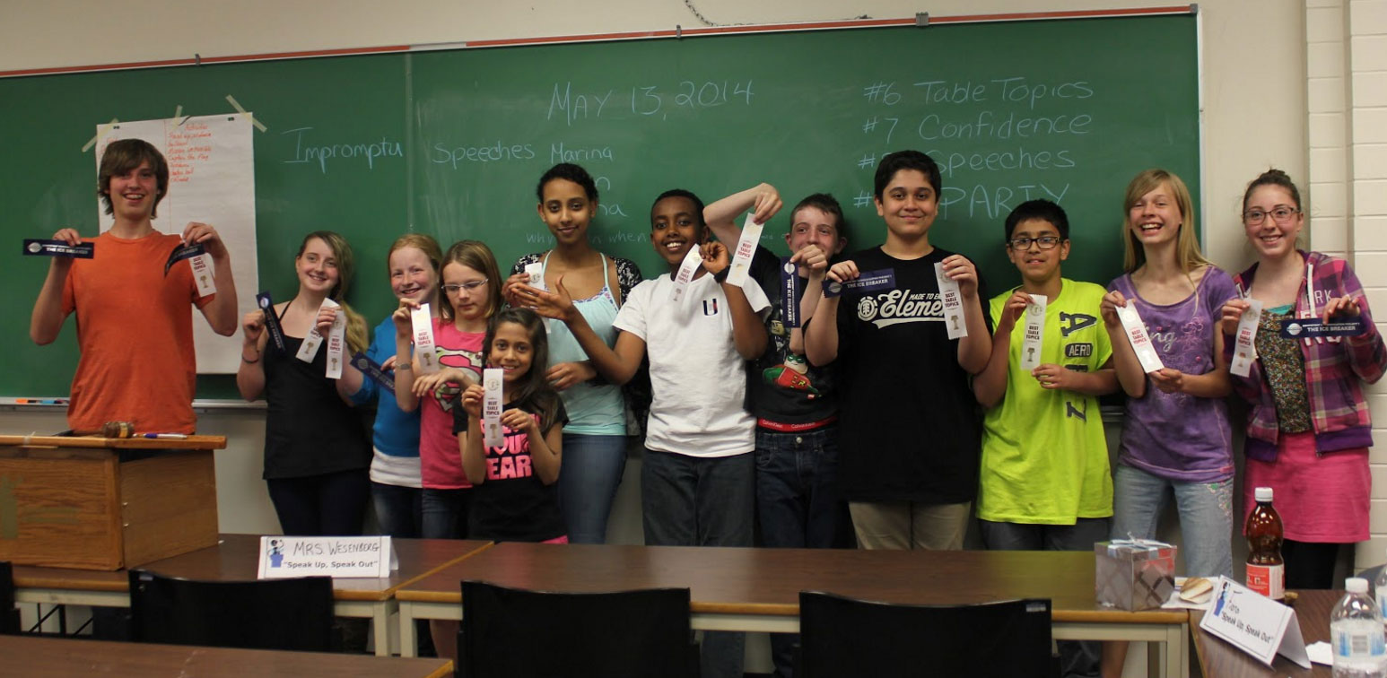 Youth holding up Toastmasters ribbons on celebrating