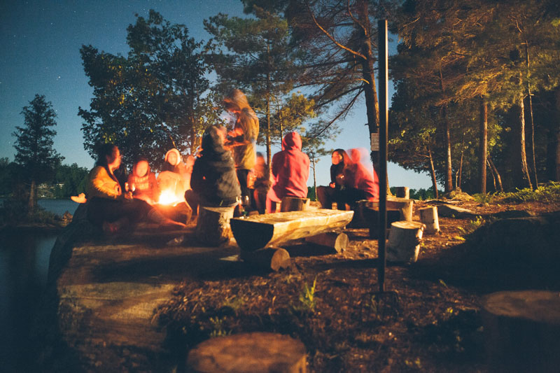 Summer Stories around an outdoor fire in the woods