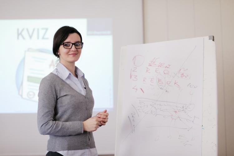 Young woman presenting in front of a flip chart