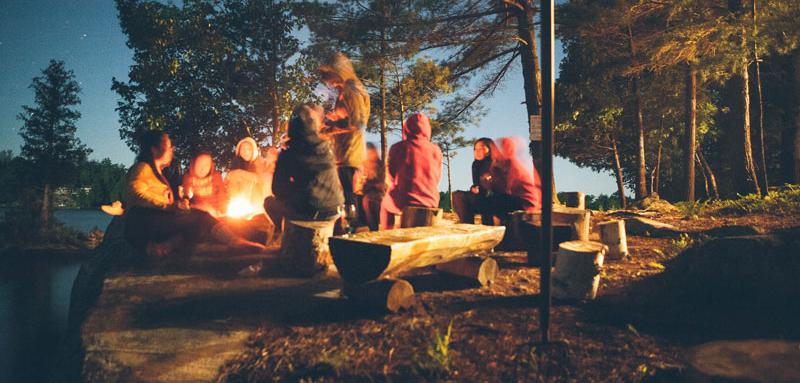 Summer Stories around an outdoor fire in the woods