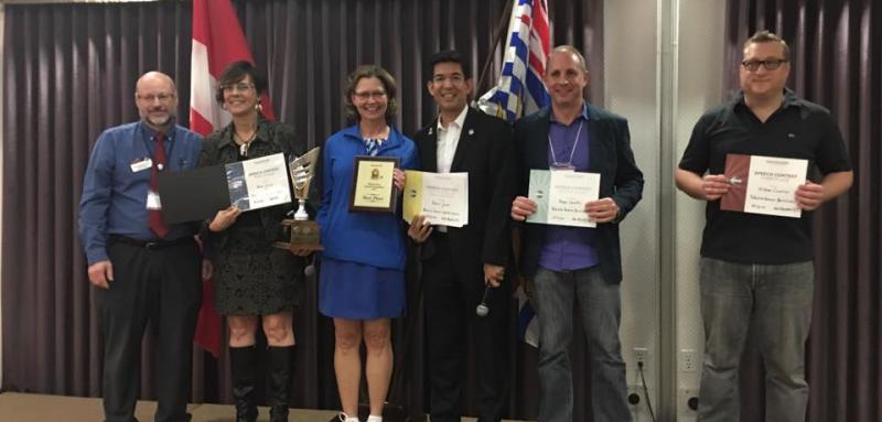 Humorous Speech Contest winners, Renne, Benny and Stefano stand with the District Trio.